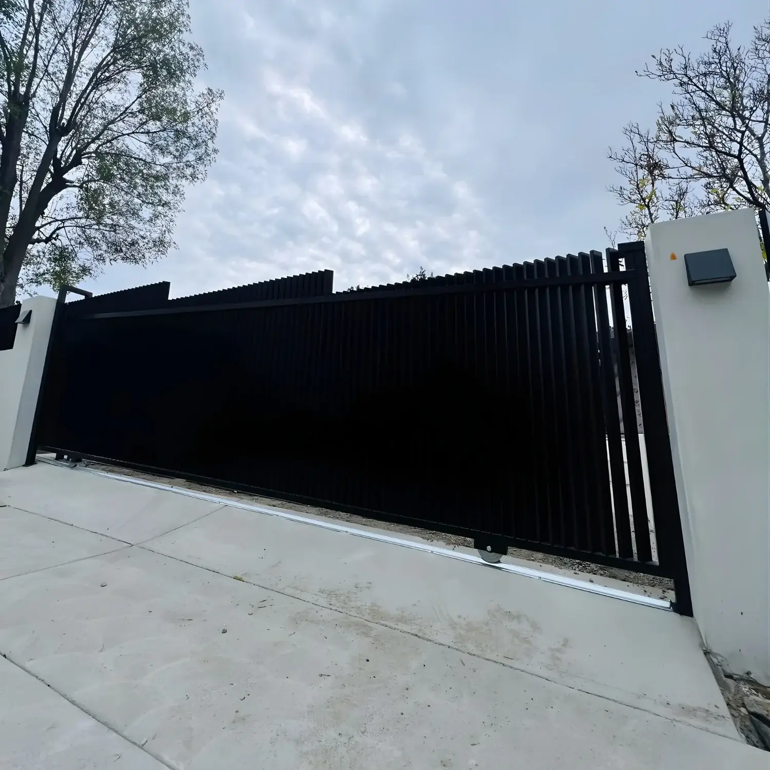 Custom black sliding driveway gate in Los Angeles